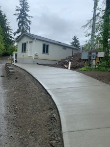A newly paved driveway leading to a house.